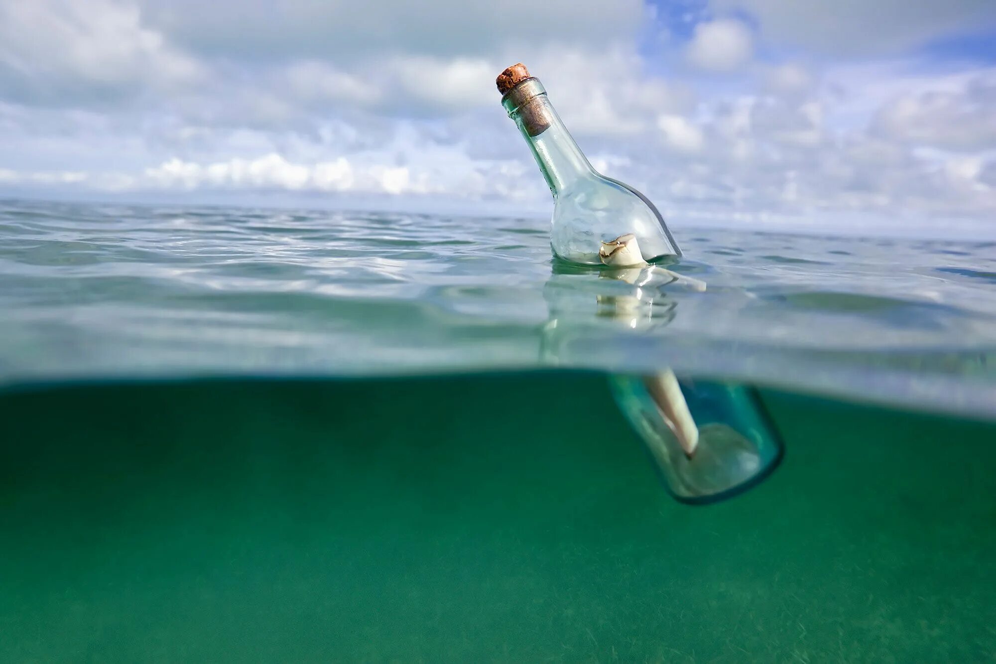 В бутылки стекает вода. Море в бутылке. Бутылка с посланием в море. Послание в бутылке. Бутылка с запиской в море.