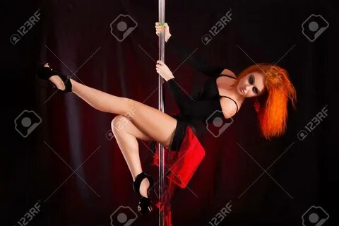 Studio photo redhead woman pole dancer - 65047533.