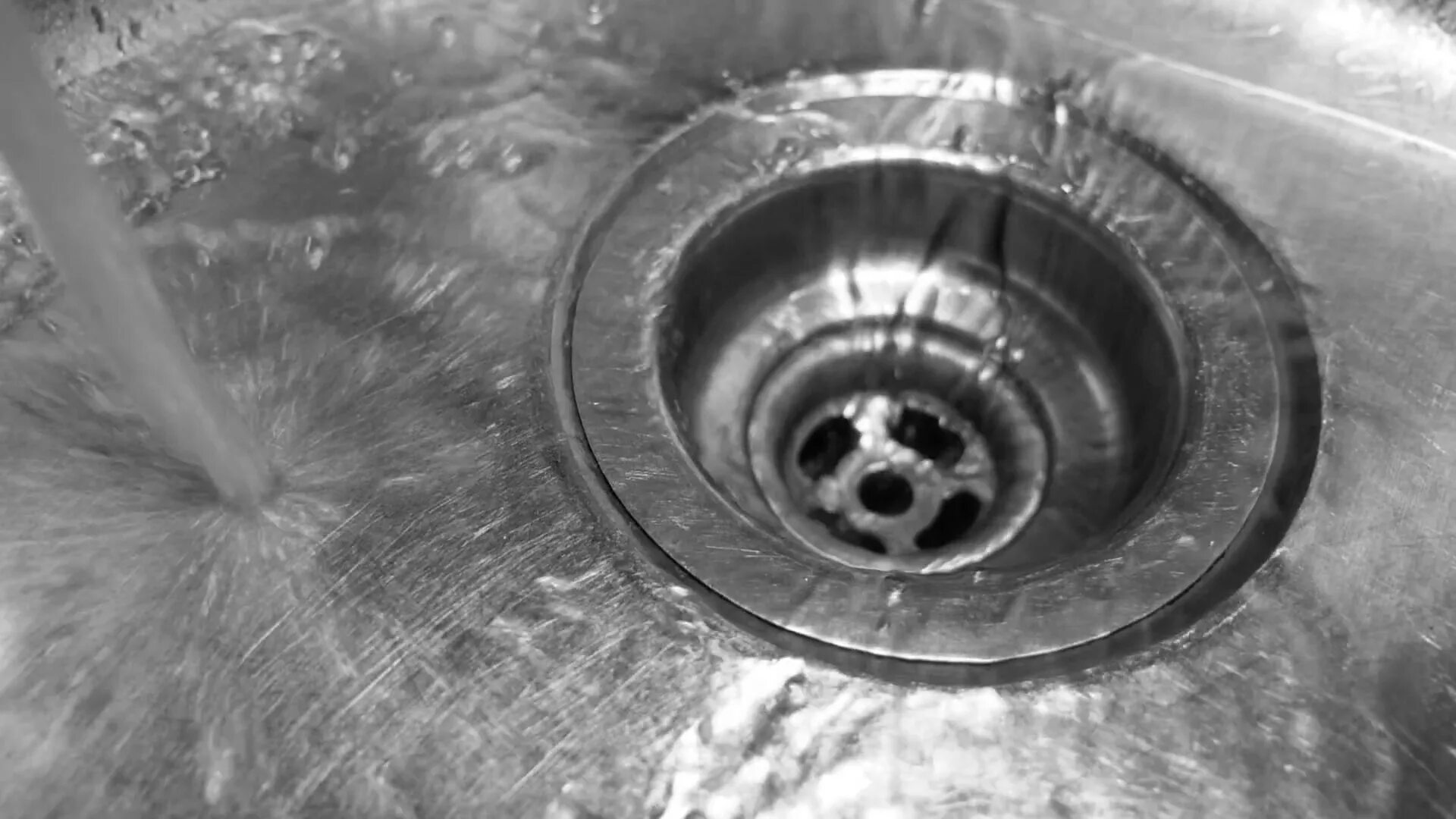 Flowing down. Granite Sink Drain hole. Down the Drain. Sink closeup. Slow draining.