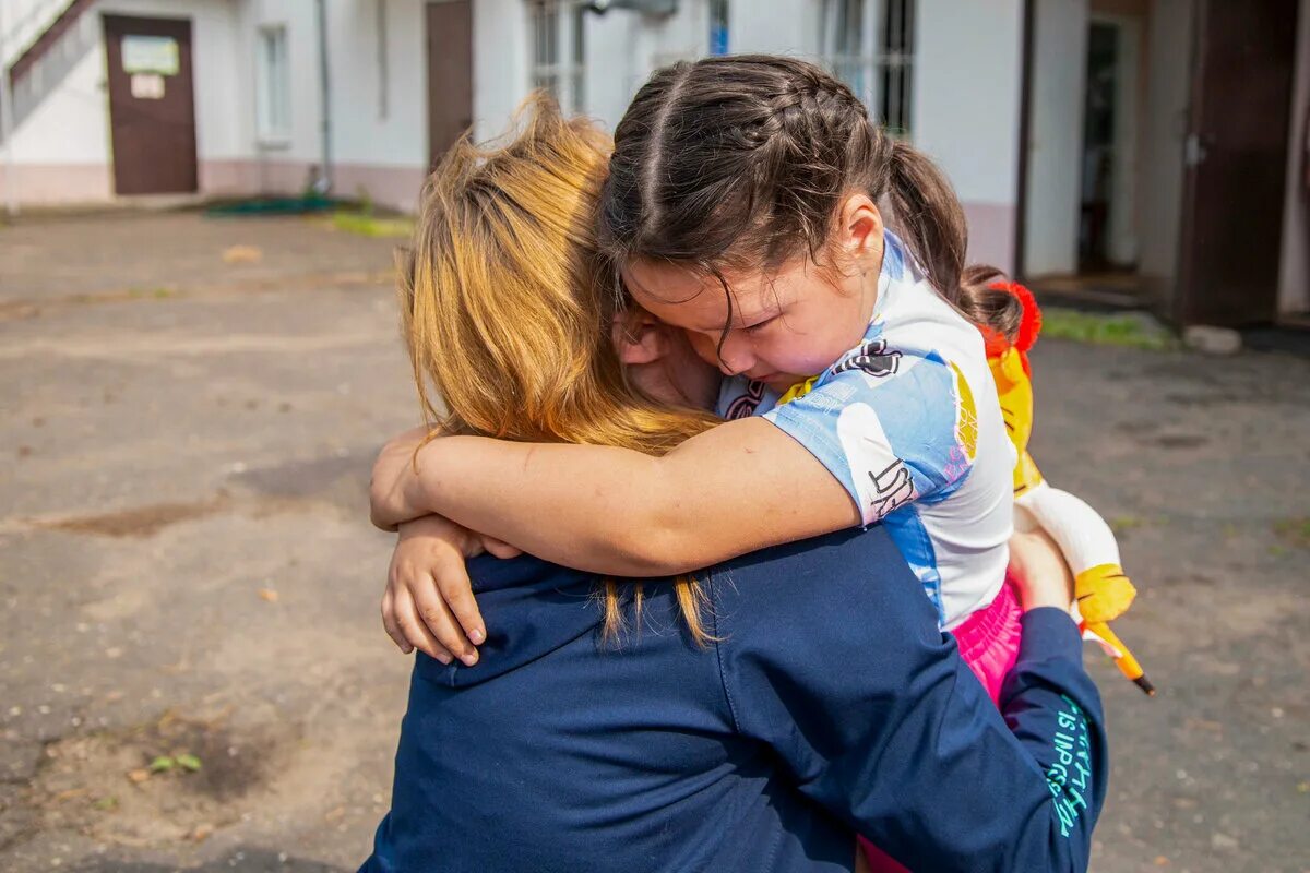 Мама обнимает ребенка под завалами. Ребенок вернулся домой. Ребенок обнимает девушку лагерь. Дети возвращаются домой. Девочка обнимается с мамой.