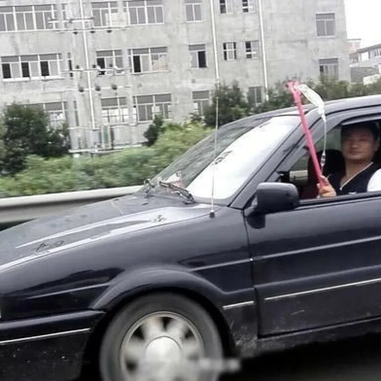 Удлиненный магазин рука торчит из тачки. Палка в авто. машина торчит из дома. высунулся из люка машины.
