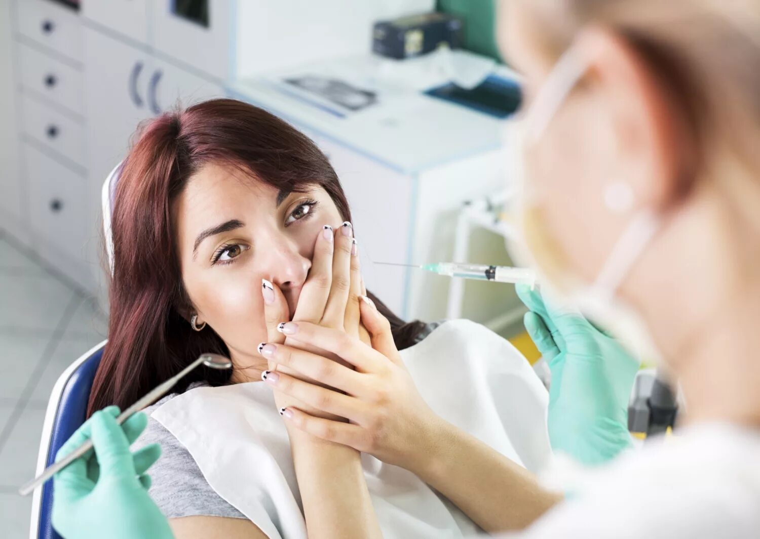 Курить после лечения зуба. Женщина на приеме у стоматолога. Пациент у дантиста.