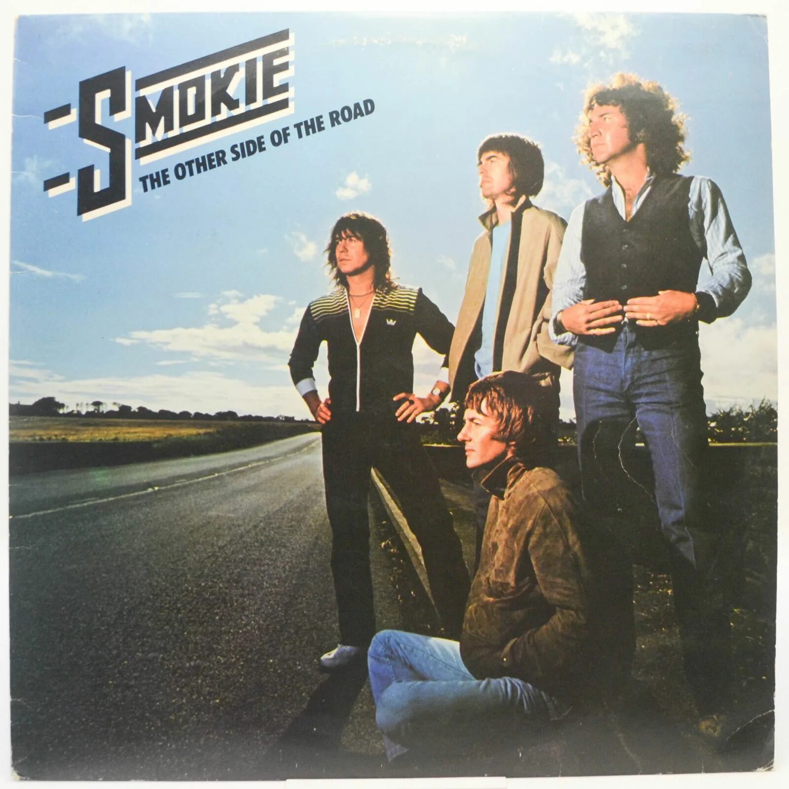 Smokie the other. Группа smokie альбомы 1979. smokie the other side of the road 1979. smokie 1976. smokie solid ground обложка.