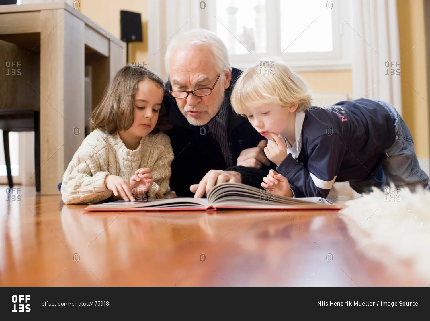 Children and grandparents reading book. Владение иностранным языком замедлило старость. Childhood old man.