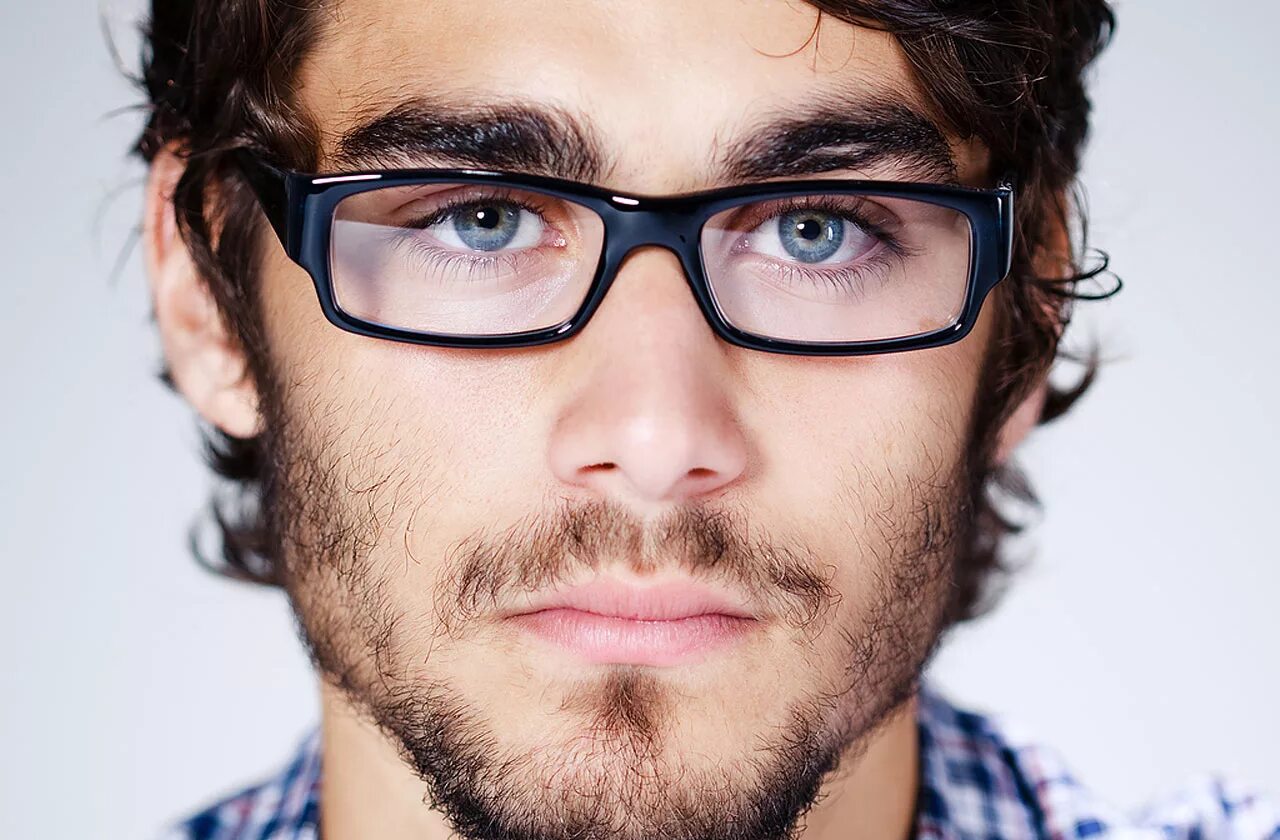 Парень снимает очки. Мужчина в солнцезащитных очках. Человек в очках щурится. Близорукий человек. Мужчина в солнечных очках.
