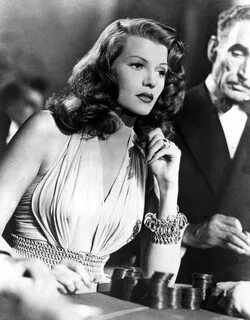 an old black and white photo of a woman in a dress with bracelets on her wr...
