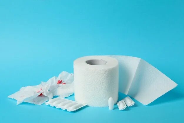 Premium Photo Fresh red blood stained on tissue paper on white table
