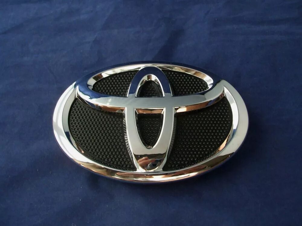 Знак тойоты машины. Toyota Emblem. Toyota Corolla Emblem. Эмблема Тойота v70. Toyota Vitz 2010 эмблема решетки.