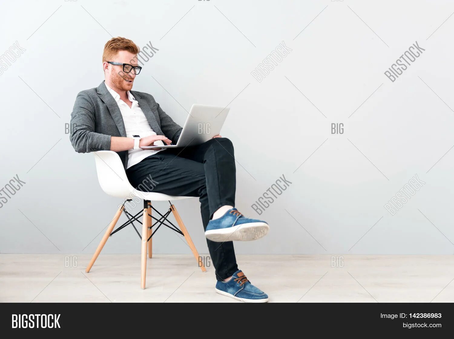 Мужчина в кресле с ноутбуком. Бизнесмен с ноутбуком. Довольный мужчина с ноутбуком в кресле. Мужчина сидит в кресле.