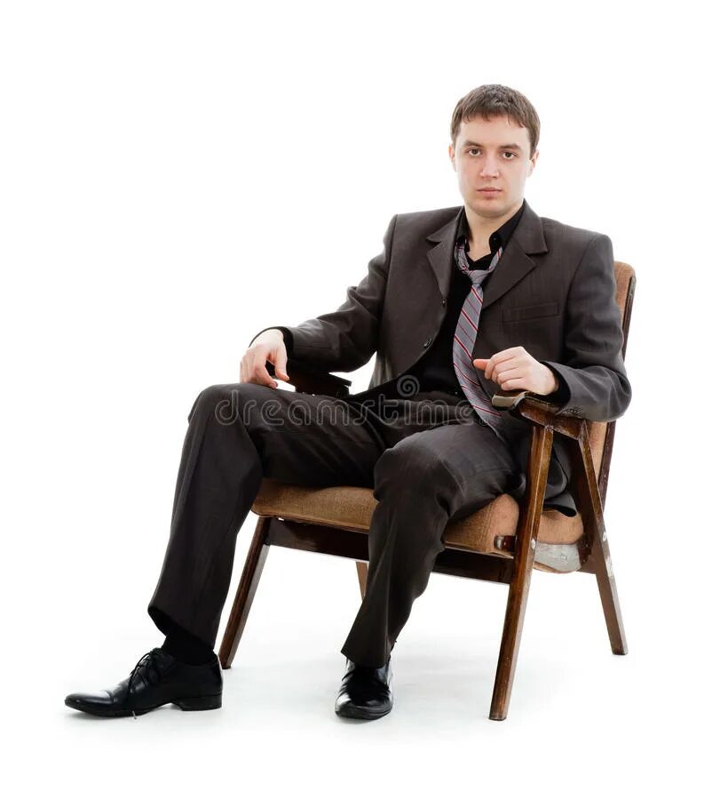 Мужчина сидит расставив ноги. Мужчина в кресле. Человек в костюме сидит. Мужчина в кресле в костюме. Человек в костюме сидит на стуле.