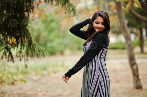 Portrait of young beautiful indian or south asian teenage girl in dress pos...