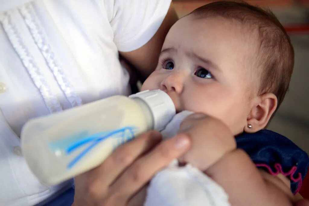 Ребенок с бутылочкой. Младенец с бутылочкой. Бутылочка со смесью. Ребенок с бутылкой молока.