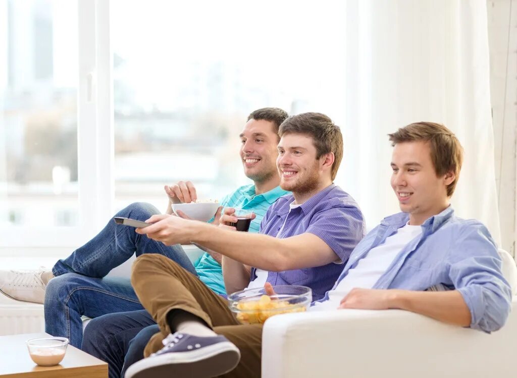 Hang out with friends. Фото человек с пультом. Man with Remote and Chips watching TV at Home. Watch TV with friends. Your friend watch tv