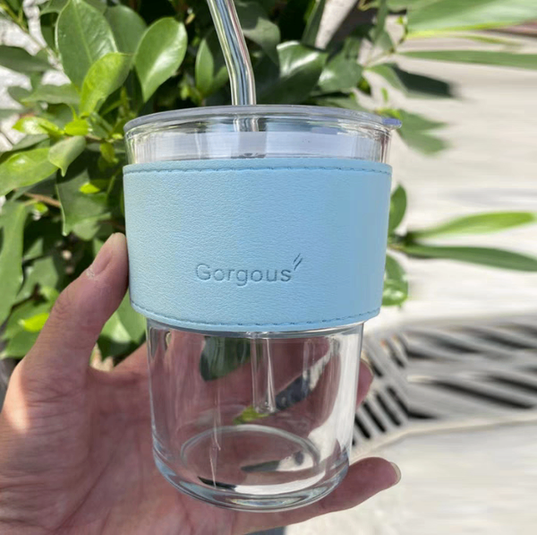 Glass tumblers with leather strap.