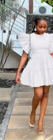 The dress is white, the sleeves and hem are multi-layered