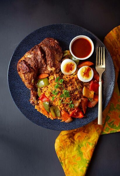 Jollof rice with grilled chicken ans boiled egg