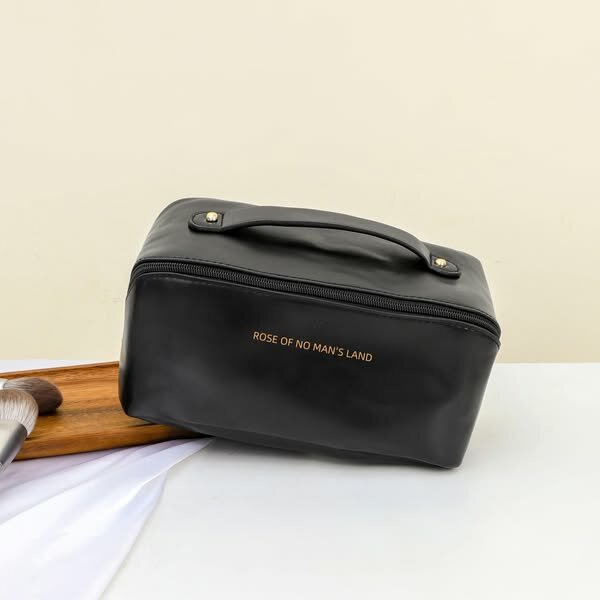 Organisateur de sac cosmétique noir avec poignée et inscription dorée